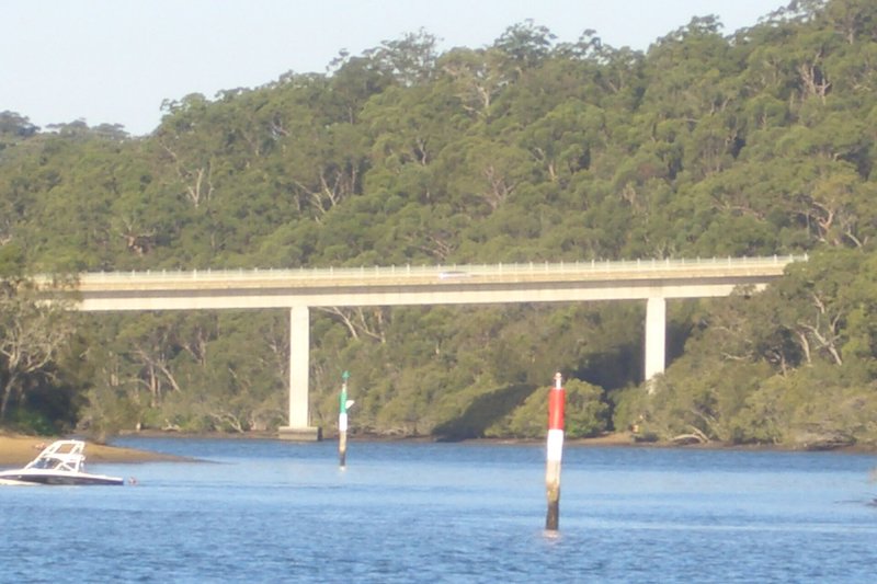 The Alfords Point Bridge crossing the Georges River below a wooded ridge