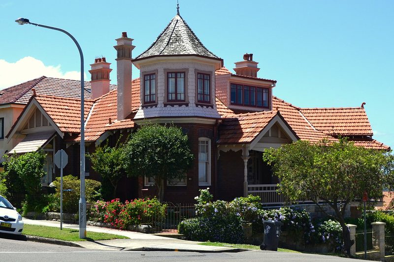 A Federation house with a shingled turret and terracotta roof on a corner in Balmoral