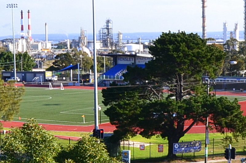 Hensley Athletic Park in Banksmeadow, with the Port Botany industrial skyline behind