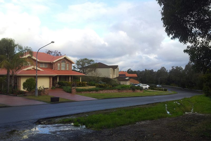 Two-storey brick homes with tiled roofs on a corner block at Barden Ridge