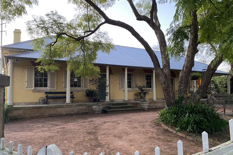 Joyce Farmhouse, a colonial sandstone and rendered house with a verandah, Baulkham Hills