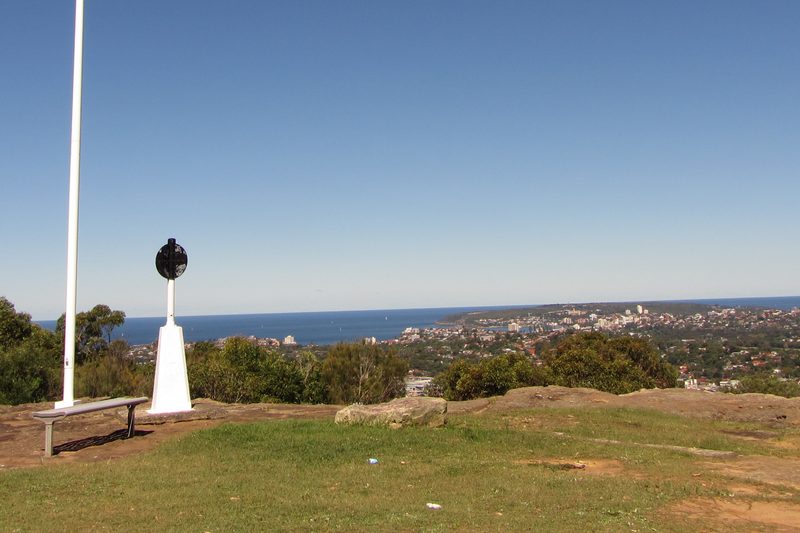The outlook from the summit of Beacon Hill, over rooftops and bushland to the coast