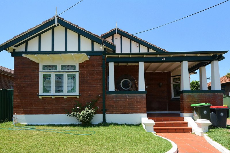 A Federation brick house with gabled roof and leadlight windows in Belmore