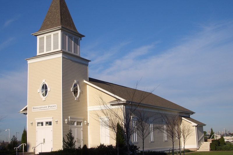 The community hall at Breakfast Point, with its weatherboard tower and shingled spire