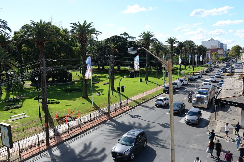 Burwood Road looking along Burwood Park, with traffic and shopfronts