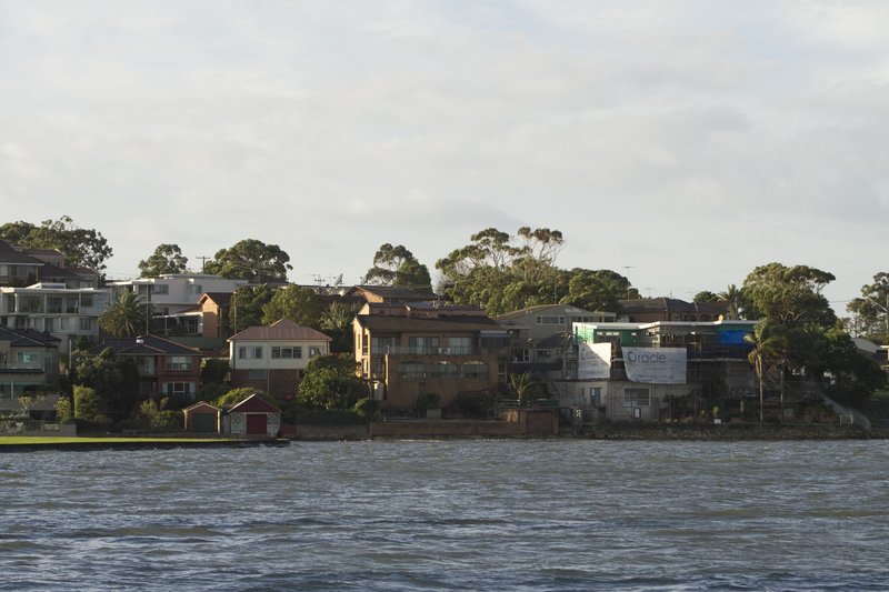 Waterfront houses and boatsheds along the Georges River at Carss Park
