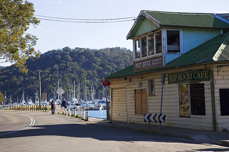 The post office and cafe at Church Point, with the marina and bushland beyond