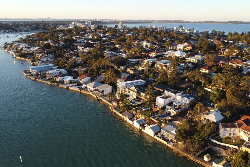Cronulla from the air at golden hour, waterfront houses along Gunnamatta Bay with the town beyond