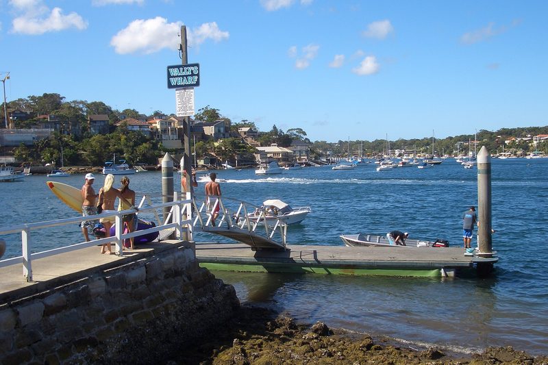 Wally's Wharf at Dolans Bay on a summer afternoon, with boats moored across the bay