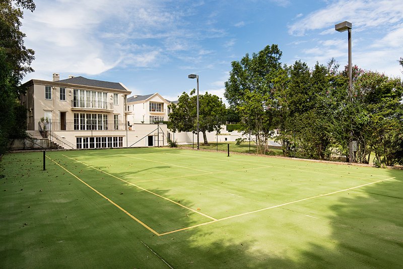 A large two storey house on an acreage block with a tennis court, Dural
