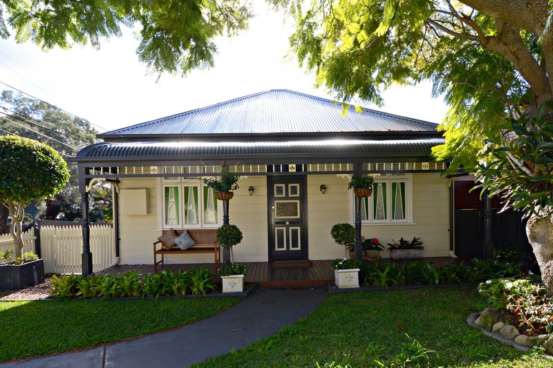 A weatherboard cottage with a verandah and picket fence on Undercliffe Road, Earlwood
