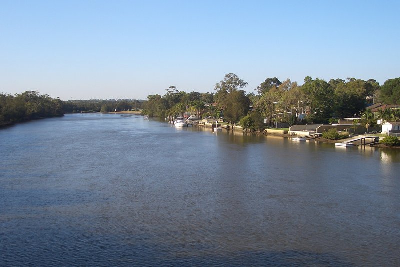 The Georges River at East Hills, with jetties and houses along the far bank