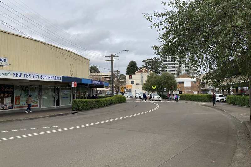 Shops along Lakeside Road in Eastwood, with an apartment tower behind