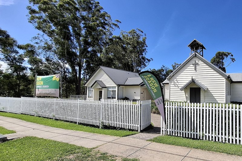 Emmanuel Anglican Church behind a picket fence, with gum trees, Glenhaven