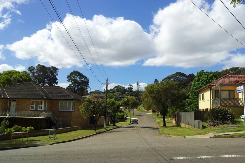A quiet residential street of brick homes in Greenacre