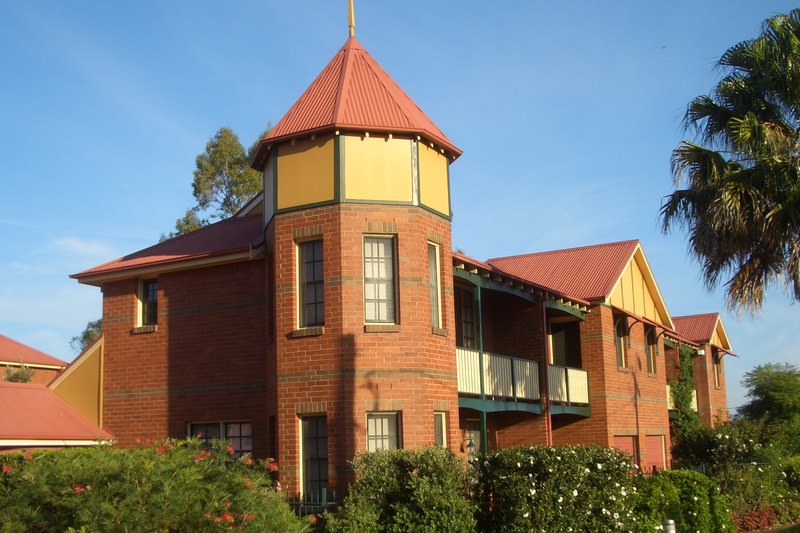 Brick townhouses with a turret and verandahs on Fowler Road, Guildford West