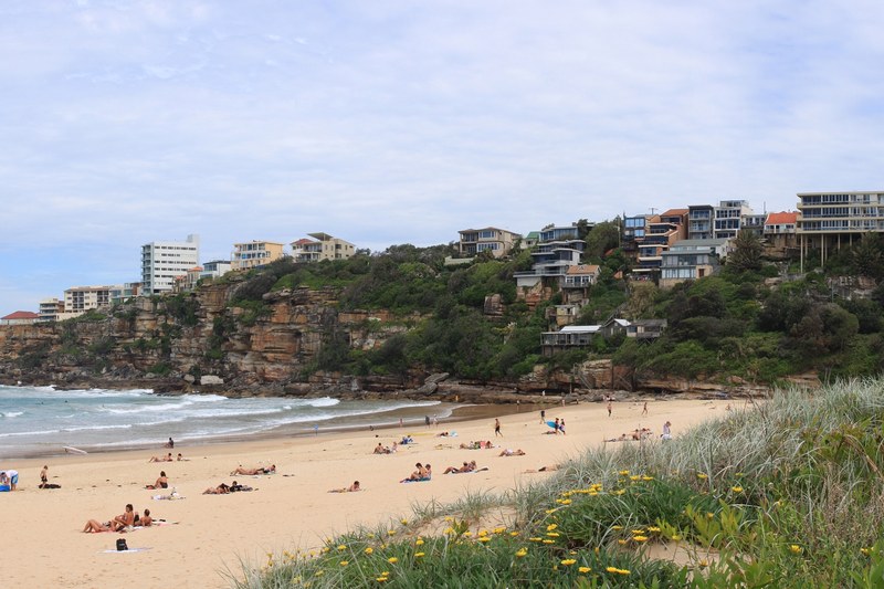 Freshwater Beach, with houses stepping down the sandstone headland above the sand