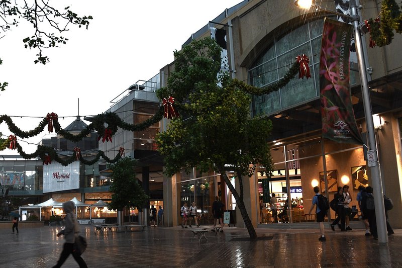 Shoppers on the wet pedestrian mall outside Westfield Hornsby after a storm