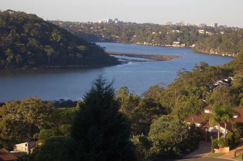 The Georges River seen from the bushy ridge at Illawong, with houses in the foreground