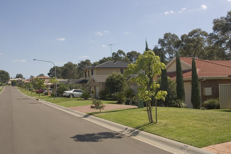 A street of two storey estate homes with wide driveways, Kellyville