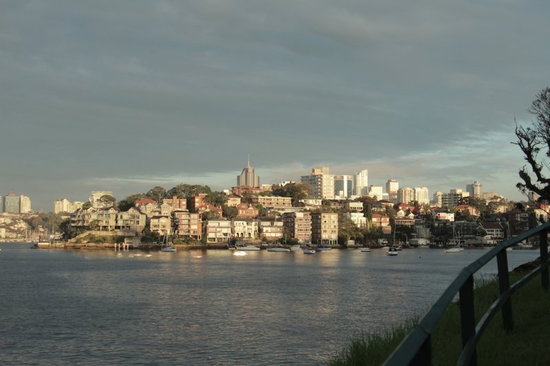 Apartments and houses stepping down the harbour peninsula at Kurraba Point, seen across the water