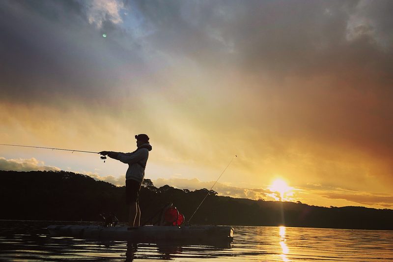 Kayak fishing at sunset on Manly Dam, Manly Vale