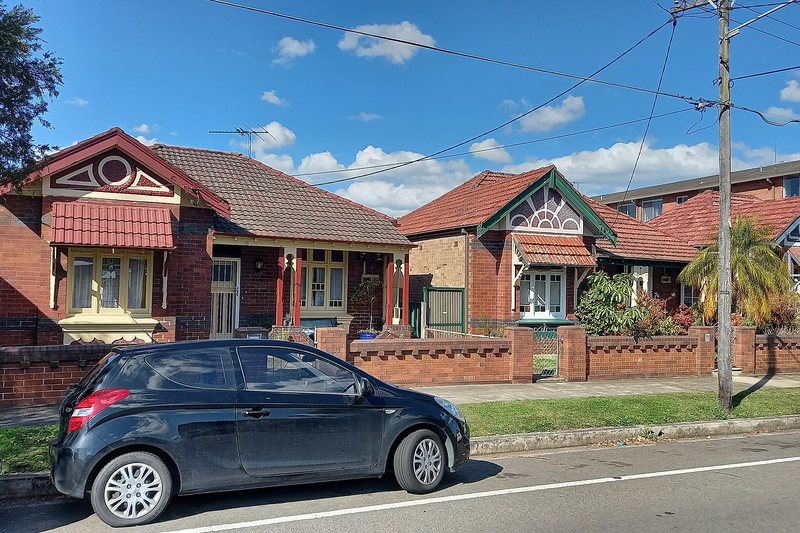 A row of Federation bungalows in Marrickville, with decorative gables and duochrome brickwork