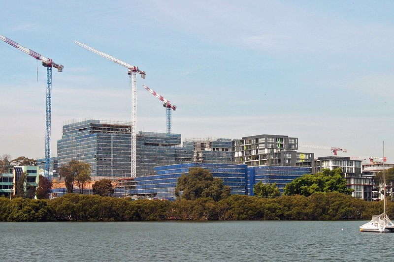 Apartment buildings under construction on former industrial land at Melrose Park, seen across the river