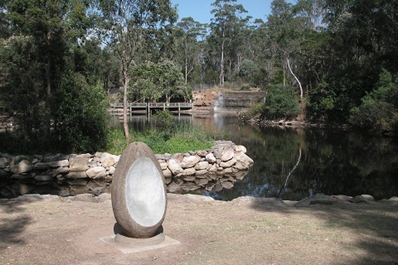 A stone sculpture beside the lake at Central Gardens, Merrylands West