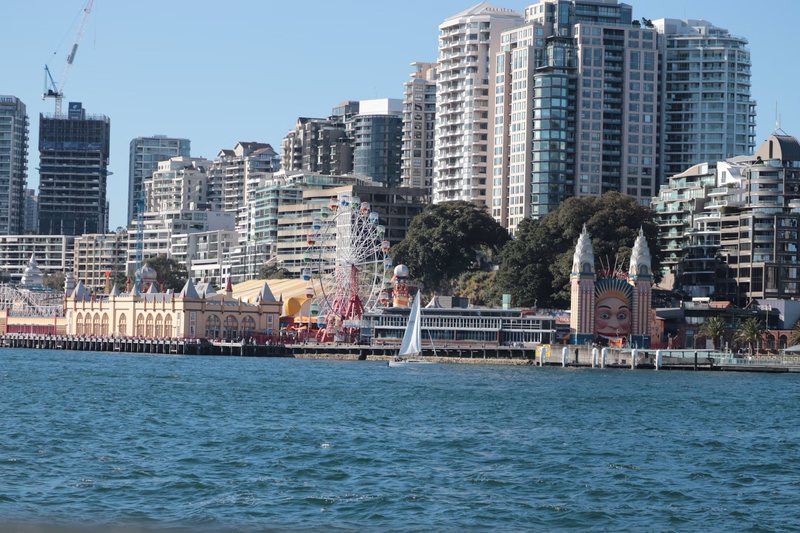 The Milsons Point foreshore from the water, with Luna Park below the apartment towers