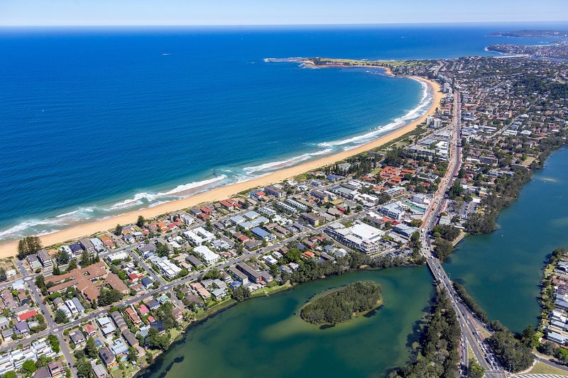 Aerial view along Narrabeen beach and Pittwater Road, with the lagoon in the foreground