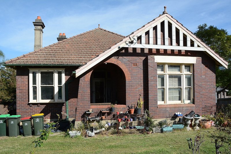 A brick Federation house with a gabled front and arched porch on Pennant Hills Road, Normanhurst