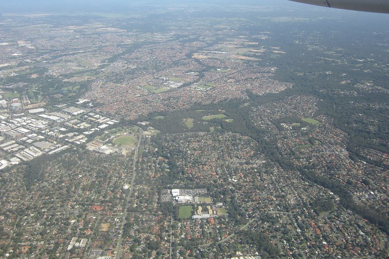 Aerial view over estate housing and bushland in the Hills District