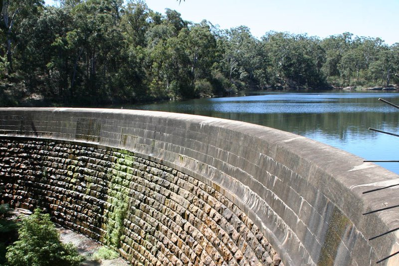 The masonry dam wall and bushland reservoir at Lake Parramatta