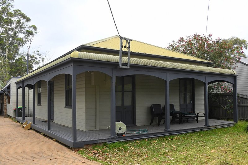 A weatherboard cottage with a deep verandah and deck, North Ryde