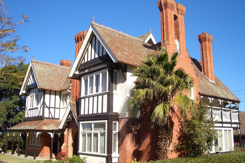 A two storey brick building with deep iron lace verandahs, Penshurst