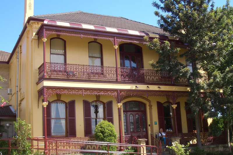 A two storey Victorian house with deep iron lace verandahs on Canterbury Road, Petersham