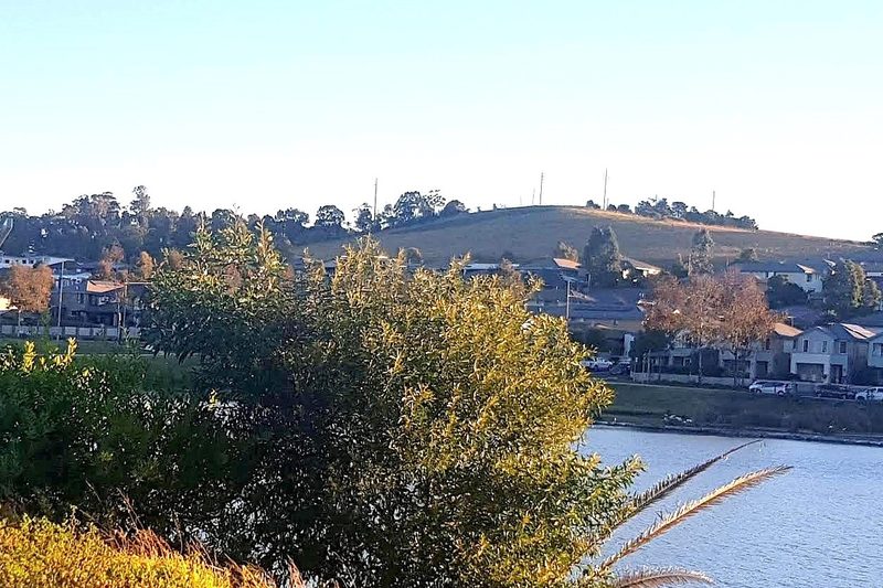 Prospect Hill rising behind houses and water on the western edge of Sydney