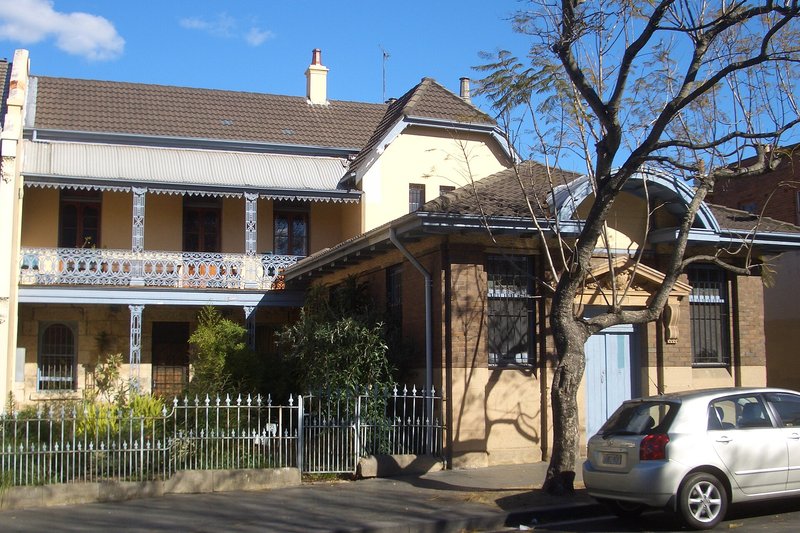 A two storey terrace with an ornate iron lace verandah on Redfern Street