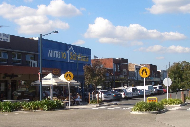 Shops and a footpath cafe on Marco Avenue in the Revesby town centre
