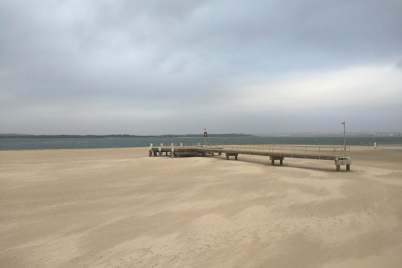 The jetty and wide sand flats on a windy day at Sandringham