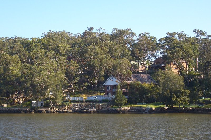 Houses set among the gums above the Georges River waterfront at Sandy Point