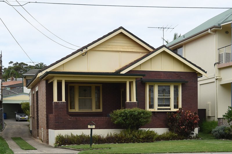 A brick California bungalow with a tiled roof and front verandah at Sans Souci