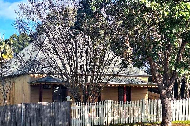 The Coleman Home on Chifley Street, Smithfield, an 1880 slab cottage behind a picket fence