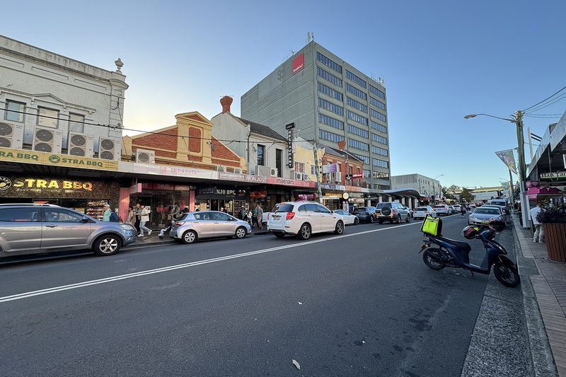 Shopfronts along The Boulevarde, Strathfield, at dusk