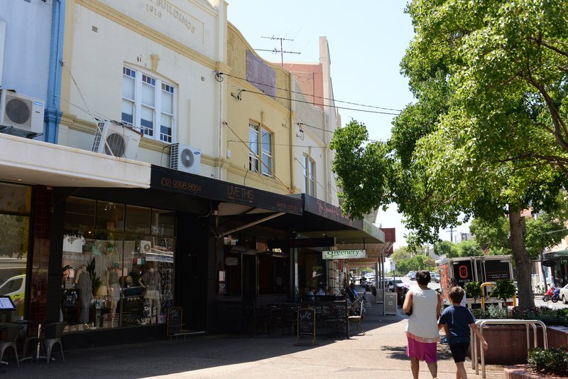 Shopfronts and awnings at The Spot, Randwick, with the 1916 heritage buildings above