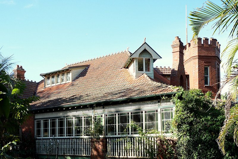 A Federation house with a brick tower and battlements on Pennant Hills Road, Thornleigh