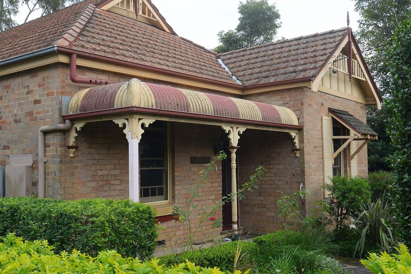 A brick Federation cottage with a bullnose verandah and timber gable at Waitara
