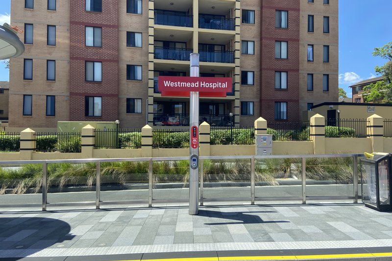 The light rail stop at Westmead Hospital, with apartment blocks behind