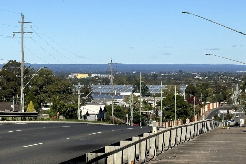 The Cumberland Highway at Woodpark, looking across rooftops towards the Blue Mountains